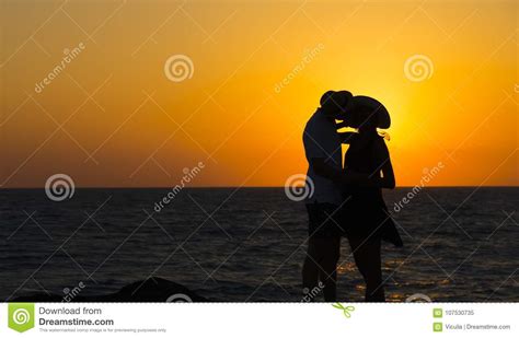 silhouette of a couple in love on the beach at sunset love