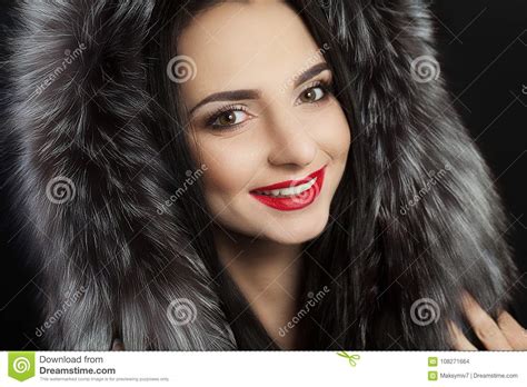 beauty is a model girl in a black fur coat beautiful