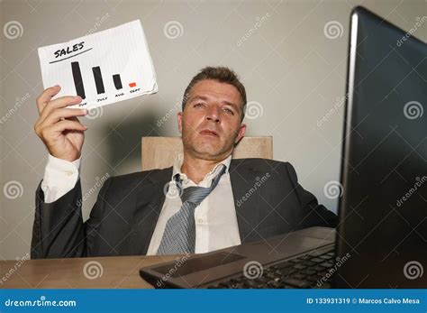 Frustrated Businessman Desperate At Office Computer Desk Holding