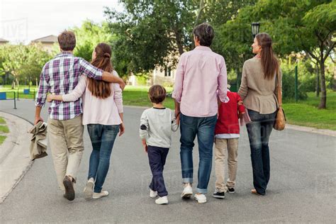 family walking   street rear view stock photo dissolve