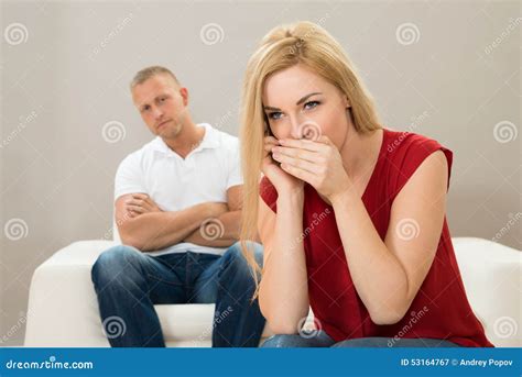 Wife Talking On Mobile Phone While Husband On Sofa Stock Image Image