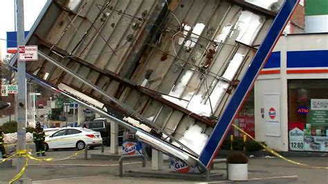 strong winds topple gas station pumping station roof  queens damage  area