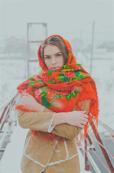 beautiful russian girl in the winter woods near a christmas tree stock