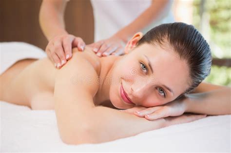 attractive woman receiving back massage at spa center stock image