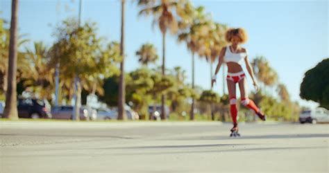 sexy girl riding on roller skates she wearing skimpy shorts socks and short t shirt all on slow