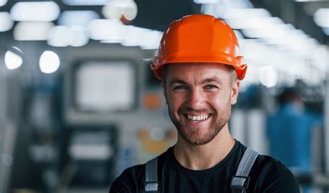 smiling  happy employee portrait  industrial worker indoors  factory young technician