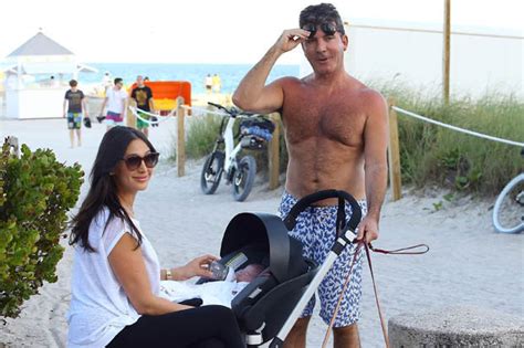 simon cowell gets his pecks out for a beach stroll with