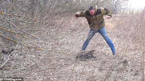 man tries to taunt an angry beaver with a stick somewhere near moscow