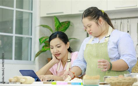 Asian Young Chubby Down Syndrome Autistic Daughter Wears Apron Learning