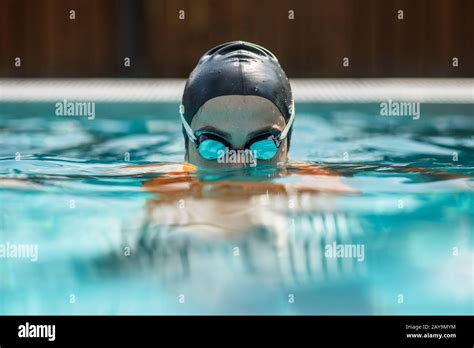Close Up Of Female Swimmer In Swimming Cap And Goggles In Swimming Pool