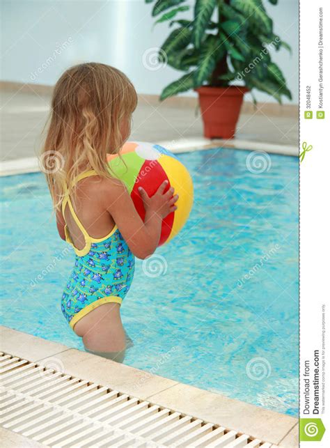 mała dziewczynka w wodnym basenie z piłką fotografia stock obraz