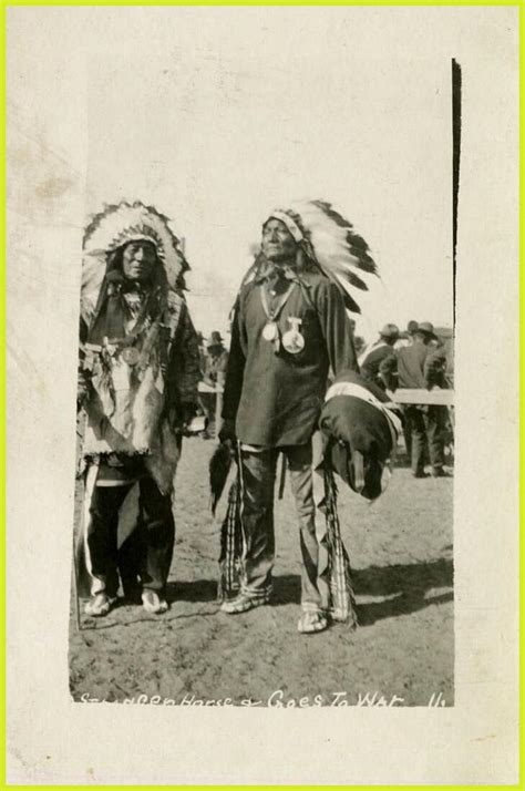 Two Native American Men In Traditional Dress And Feathered