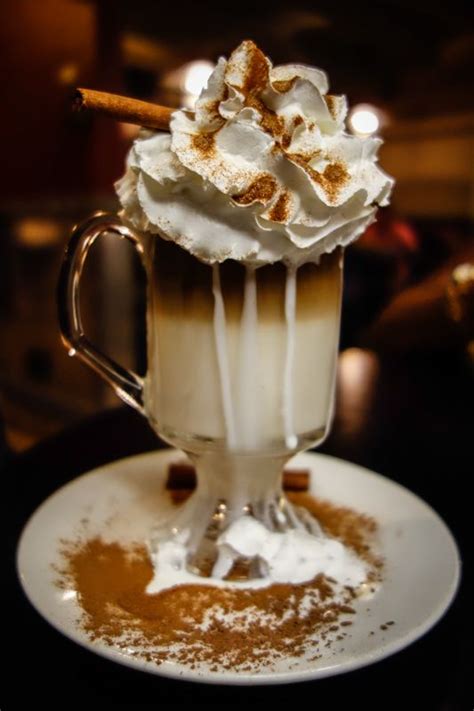cup filled  whipped cream  cinnamon  top   white sauce