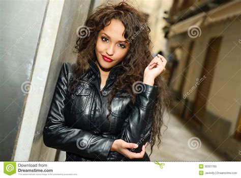 attractive black woman in urban background wearing leather