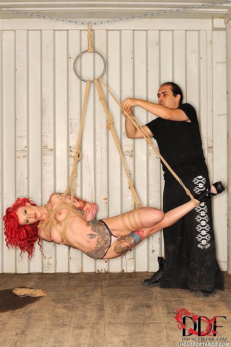 tattooed redhead fetish model becky holt suspended by rope for bdsm shoot