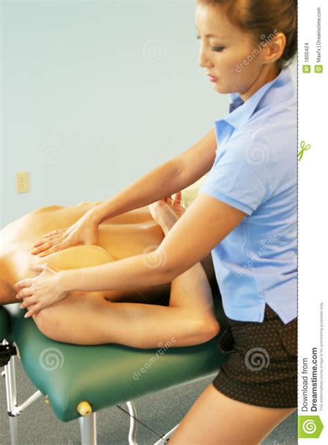 massage therapy therapist giving back massage stock