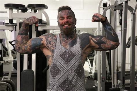 bodybuilder covers up his tattoos with fake tan others