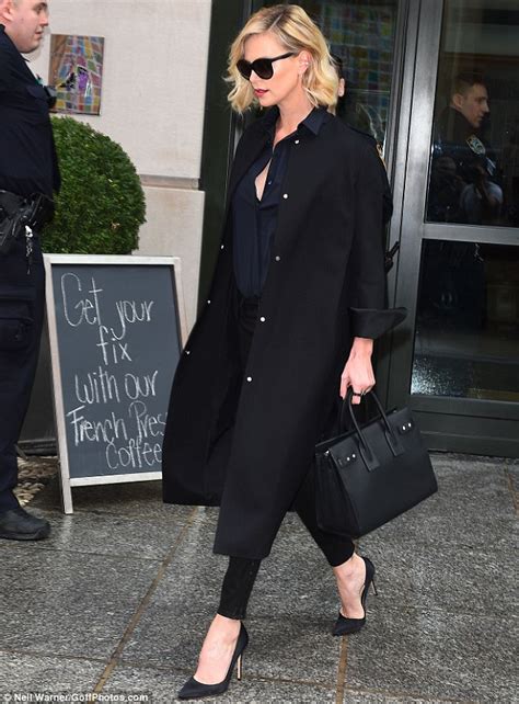 charlize theron shows off legs in leather leggings in nyc