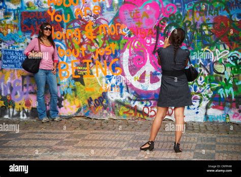 The John Lennon Graffiti Wall In Prague Czech Republic Tourist Woman