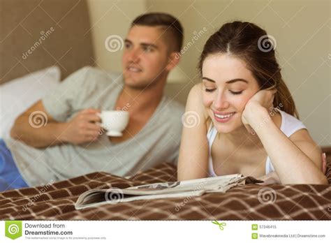 cute couple reading newspaper in bed stock image image of foreground female 57346415