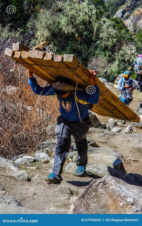 man carrying heavy load editorial photo image