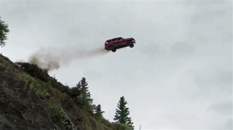 bunch  beater cars  flying    foot cliff  alaska