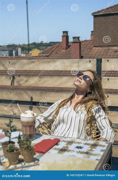 woman with sunglasses sunbathing on the terrace stock image image of