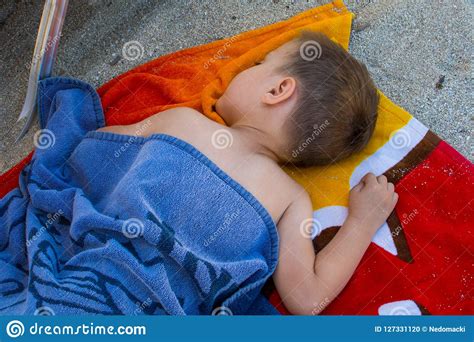 boy sleeps   beach   sand stock photo image  coast
