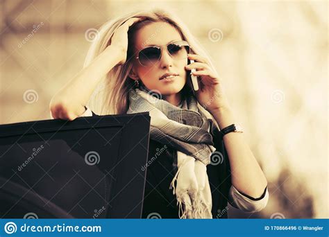 Fashion Business Woman In Sunglasses Talking On Cell Phone Outside A
