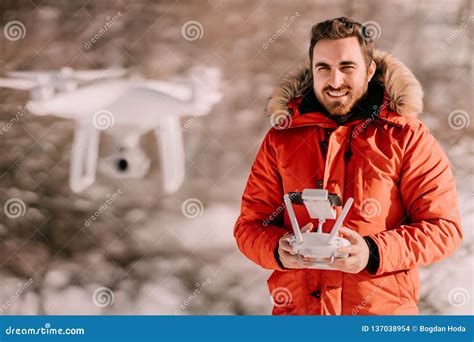 close  portrait  young adult caucasian male operating drone flying drone  remote