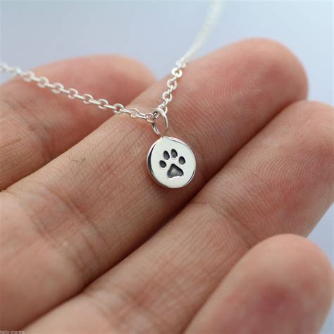 tiny paw print necklace  sterling silver paw charm  dog cat