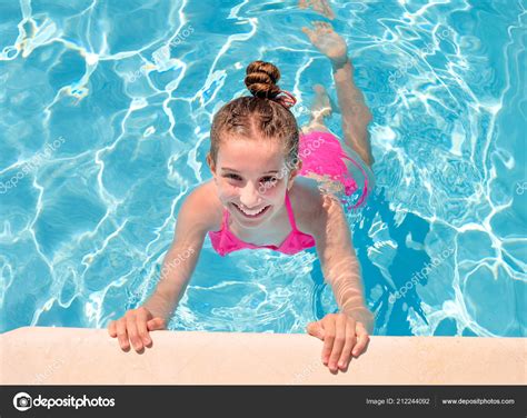 teen girl  swimming pool squinting  eyes stock photo  ctanikk