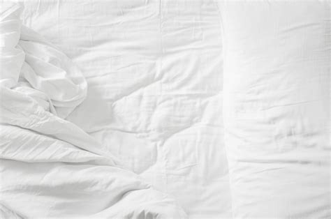 premium photo top view white pillows  blanket  empty bed sheet