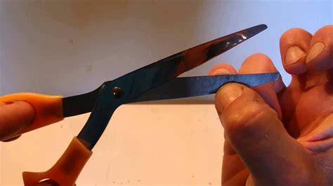 cut  fingernails    hand  paper scissors held