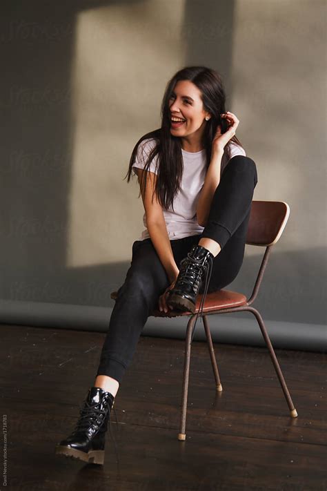 Laughing Trendy Model Posing On Chair By Danil Nevsky