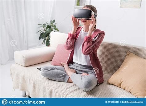 Girl Sitting In Lotus Position With Virtual Reality Headset Stock Image