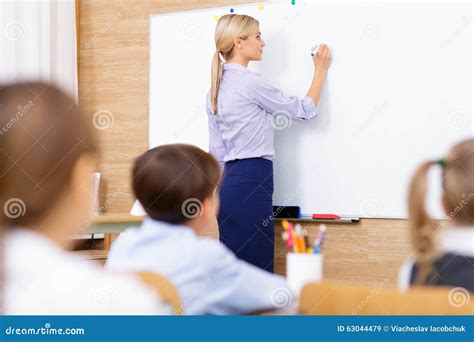 teacher writing   whiteboard stock image image  understudies