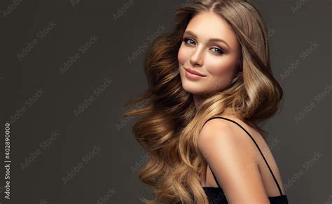 beauty blonde girl with long and shiny wavy hair beautiful woman
