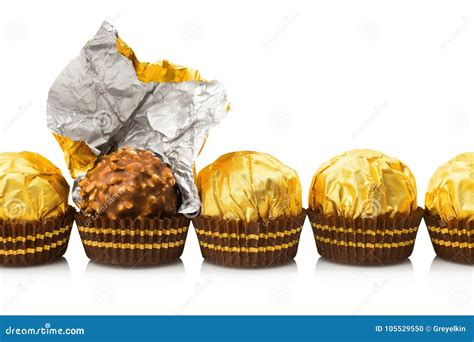 candy  gold wrappers isolated stock photo image  dessert gold