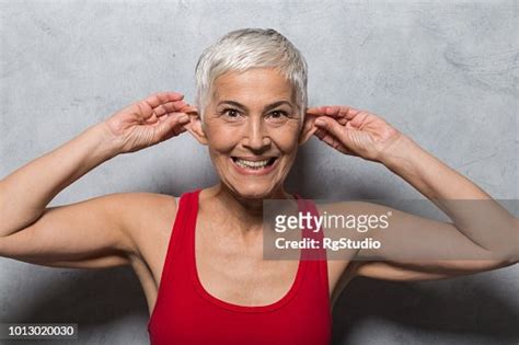 Silly Mature Woman Making A Face And Pulling Her Ears High Res Stock