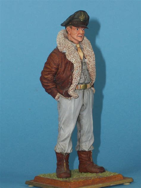 figurine    man   jacket  hat  top   wooden base