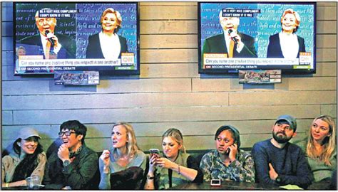 people gather to watch the presidential town hall debate