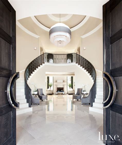 contemporary white entry  double staircase luxe interiors design