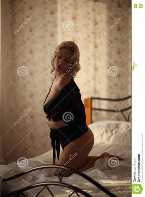 beautiful smiling blond woman with long slim legs posing