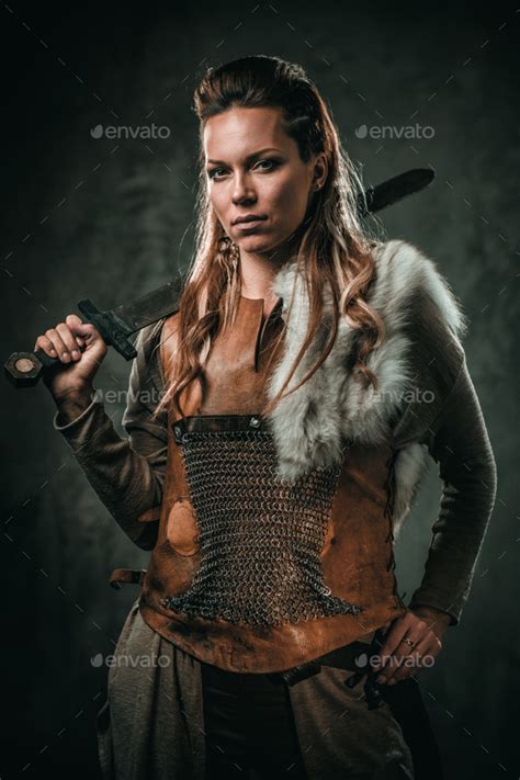 viking woman with cold weapon in a traditional warrior