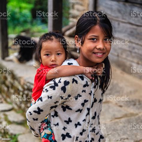 Nepali Girl Carrying Her Sister Village Near Annapurna Range Stock