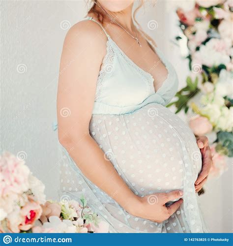 sensuality pregnant in lingerie dress embrasing stomach