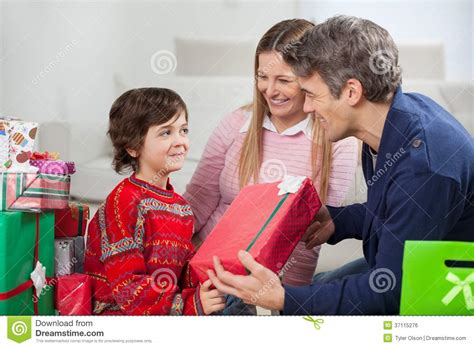father giving christmas t to son royalty free stock image image 37115276