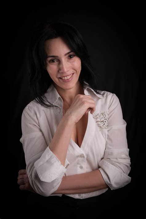 Portrait Of Beautiful Mature Brunette Woman Dressed In White Shirt