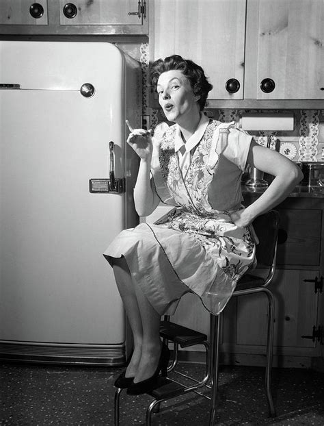 1950s housewife sitting on stool photograph by vintage images fine